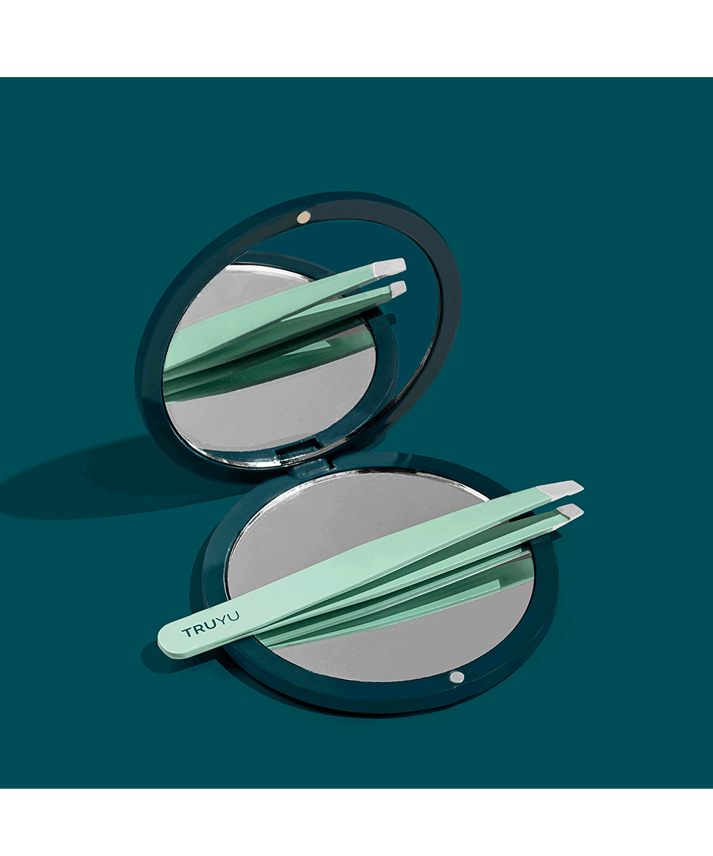 TRUYU Compact Mirror and Slant Tip Tweezer. Out of Packaging on blue background.